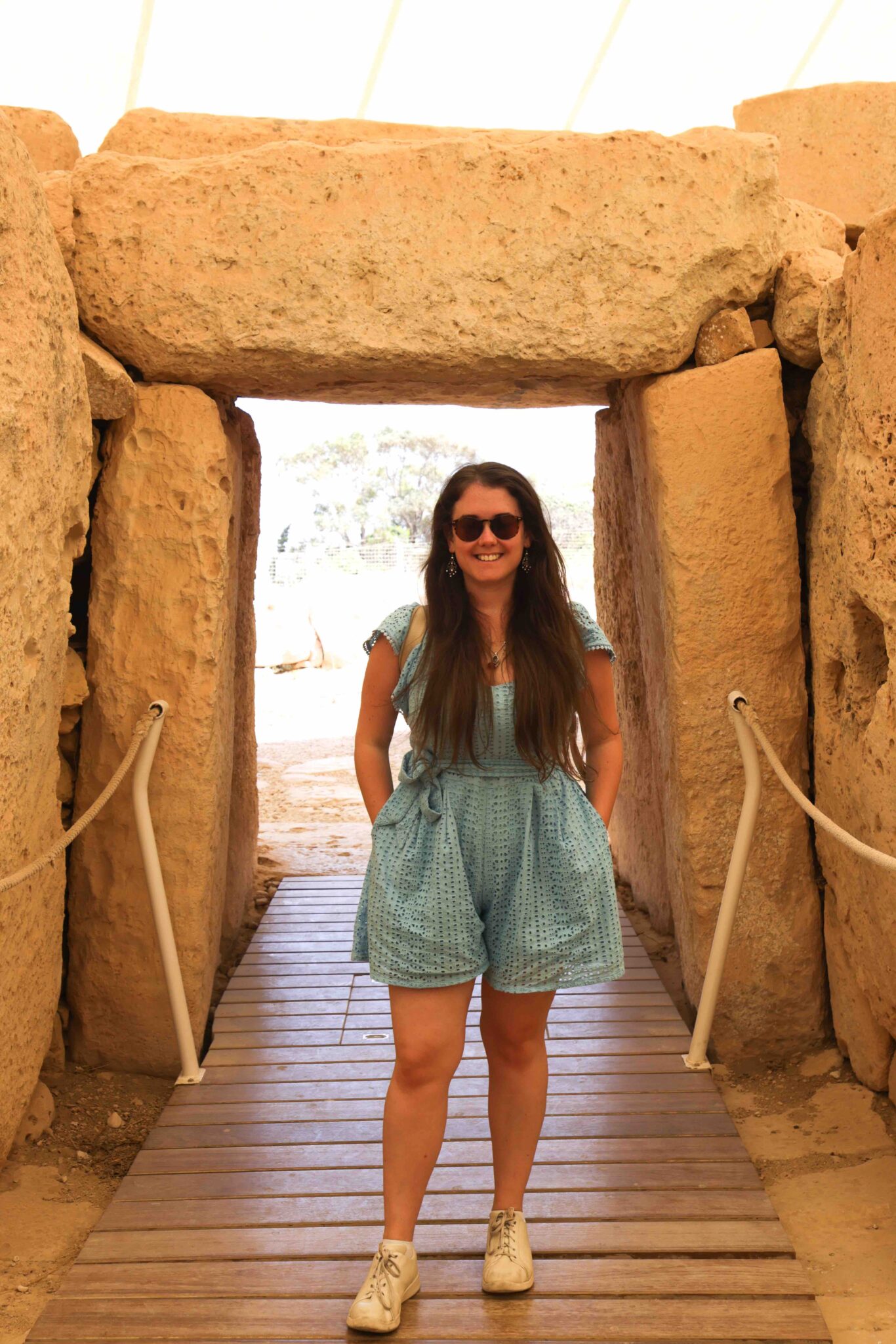 Jade Braham in Malta standing in an ancient temple.