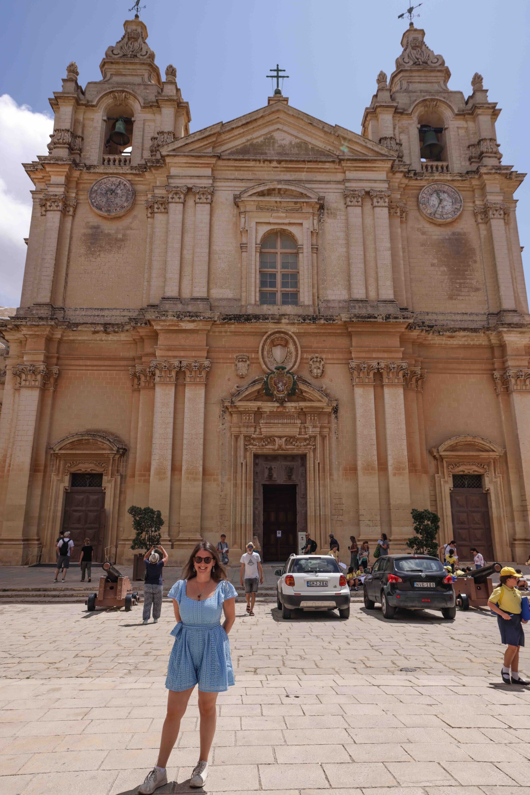 Jade Braham standing in front of Mdina's cathedral.
