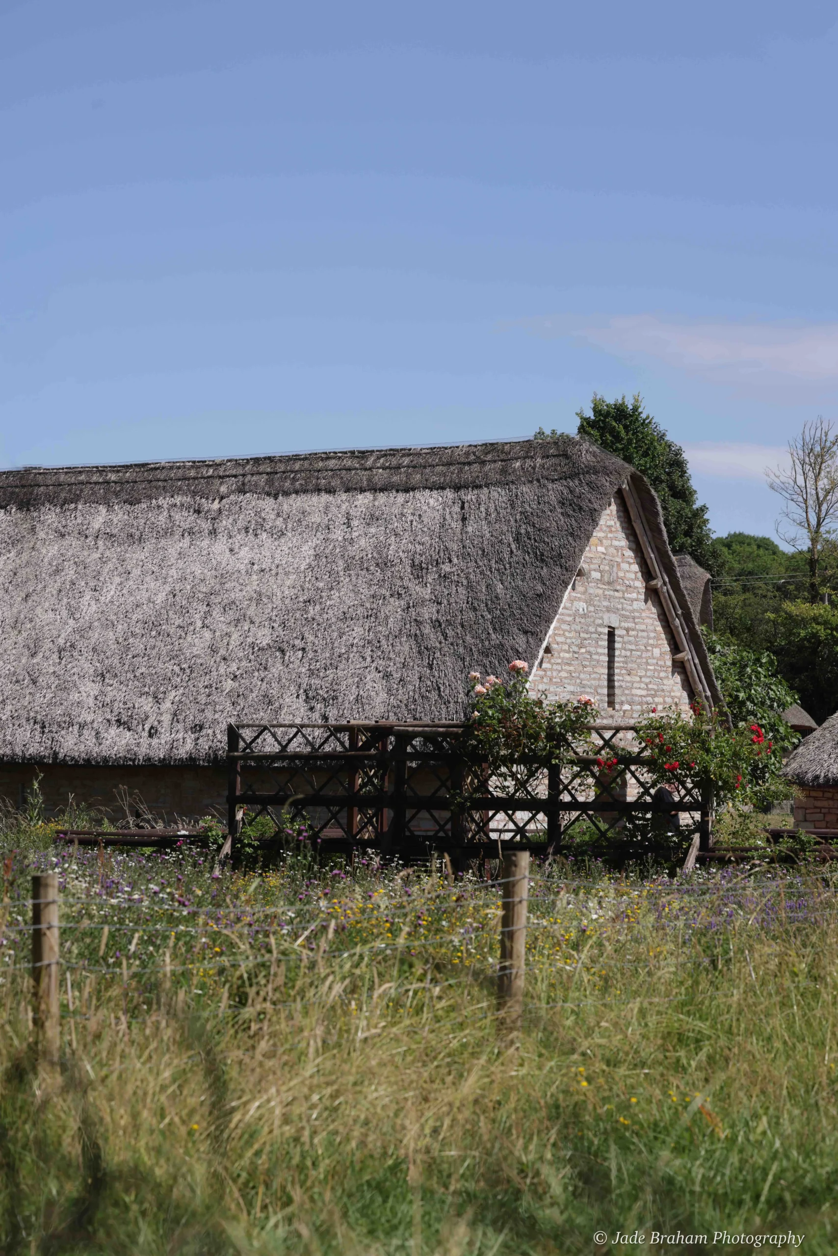 A medieval, thatched-roof hut sits in a field in the Vale of Glamorgan.