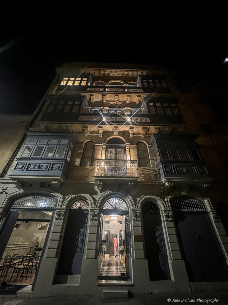 Palazzio Ignazio facade at night is alight with lamps. 
