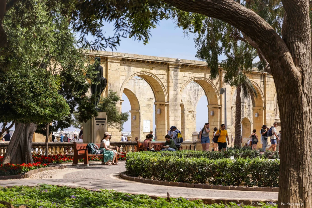 A lady sitting on a bench in the Upper Barrakka Gardens in Valletta. 