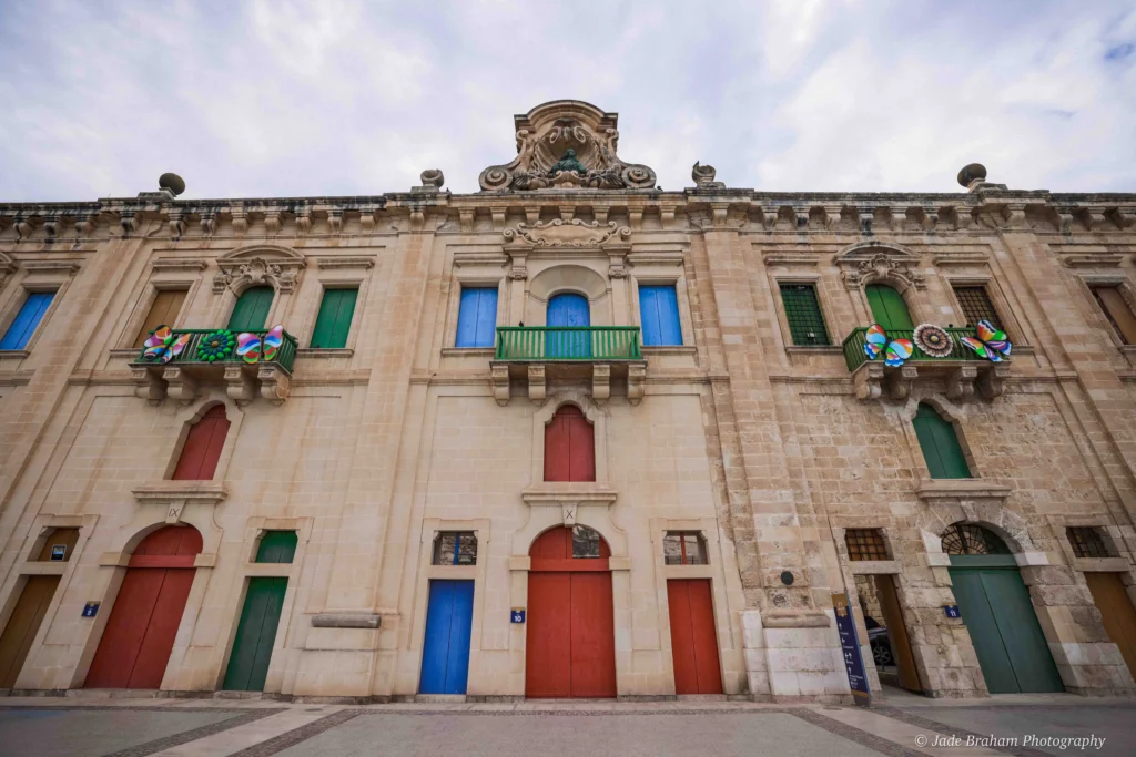 Historic buildings at Valletta's waterfront have red, green, yellow and blue doors.