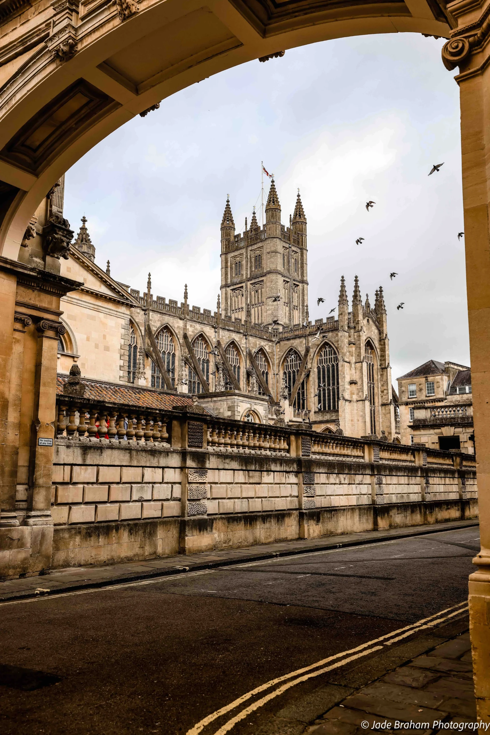 Bath Abbey with birds flying over it