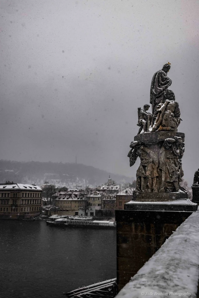 The Charles Bridge in Prague is covered with snow. 