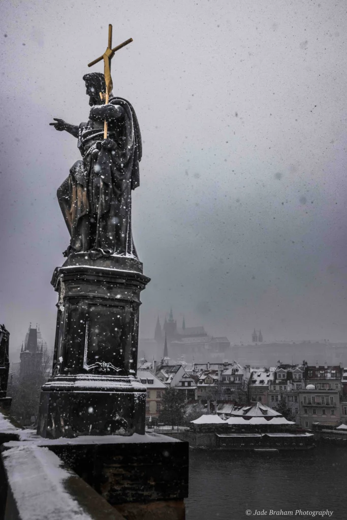 The Charles Bridge in Prague is covered with snow. 