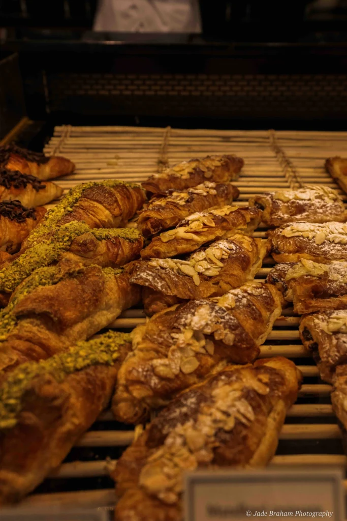 A row of almond croissants in Paul's Cafe.