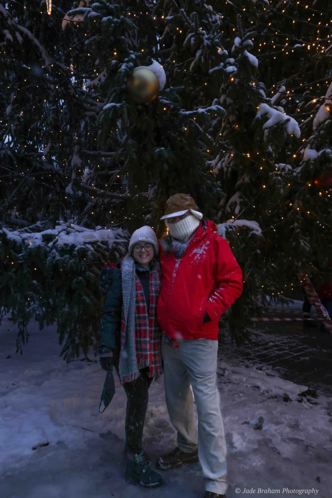 Jade standing in front of a Christmas tree in Prague's Xmas market. 