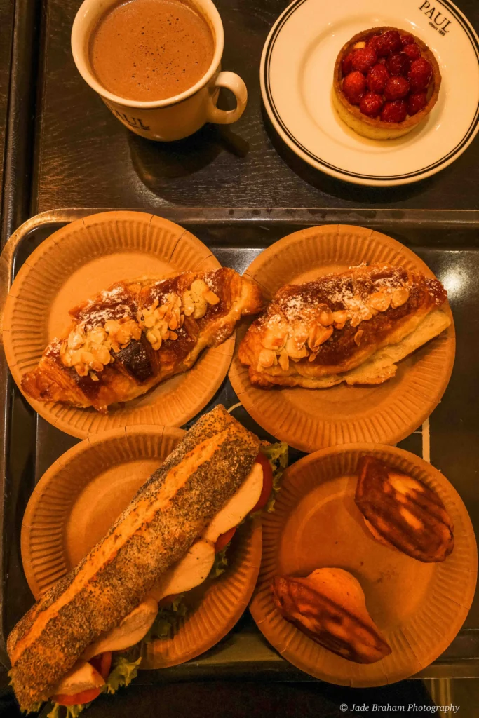 A weekend in Prague must include a visit to Paul's Cafe. Here, we have two almond croissants, a raspberry tart, two madeleines and a chicken sandwich. 