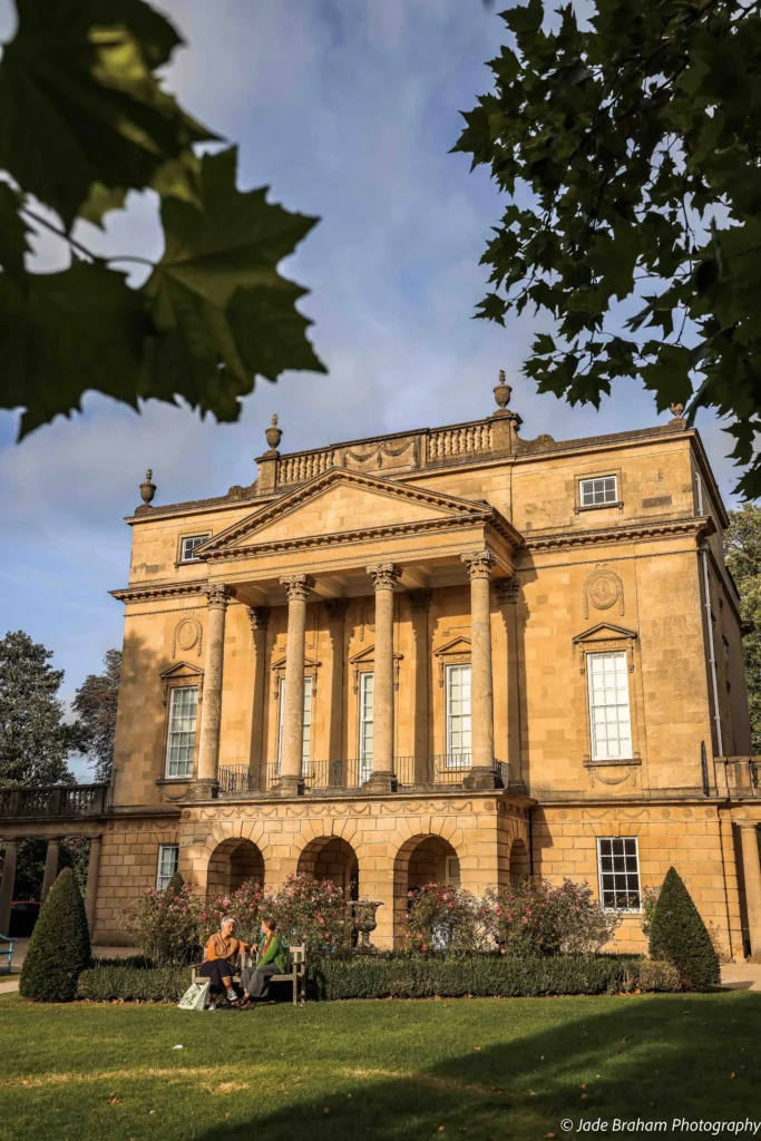 The Holburne Museum facade has columns and ladies sitting outside the front