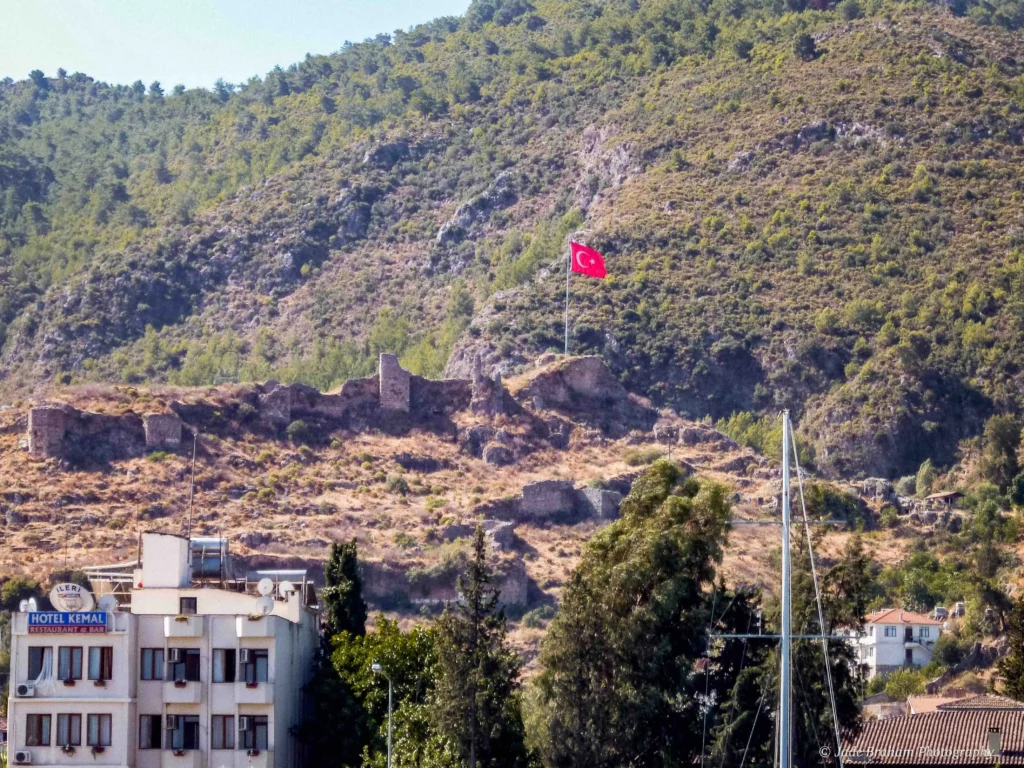 Fethiye Castle is surrounded by green mountains. 