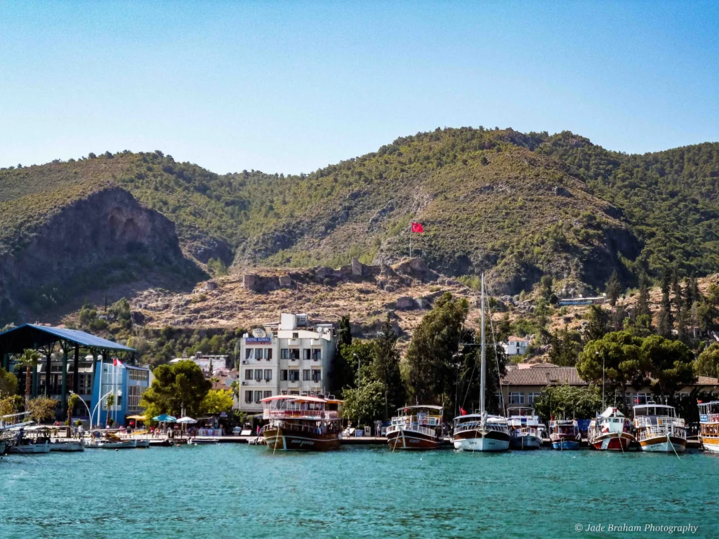 Fethiye Harbour is full of boats backed by green mountains. 