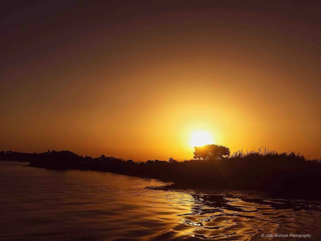 There is an orange sunset from the water taxi between Fethiye and Çalis. 