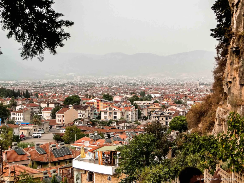 Standing at the top of Fethiye Castle with views of the city. 