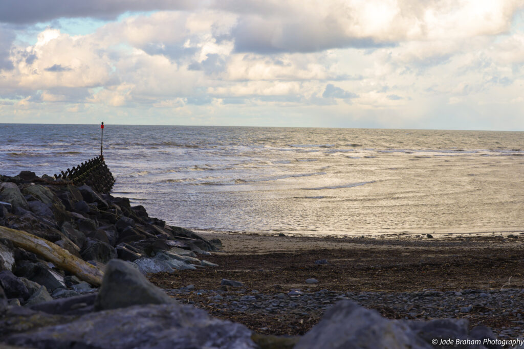 Aberaeron's beach is awash with yellow hues as the sun is setting. 