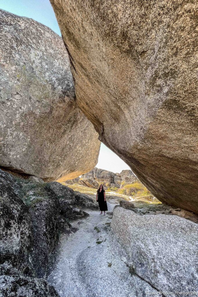 Stand beneath a boulder in Monsanto. 