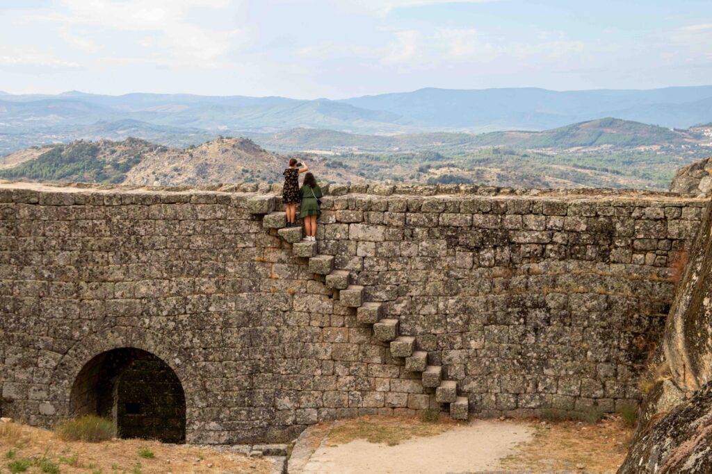 There are stone steps and long walls at Monsanto Village.